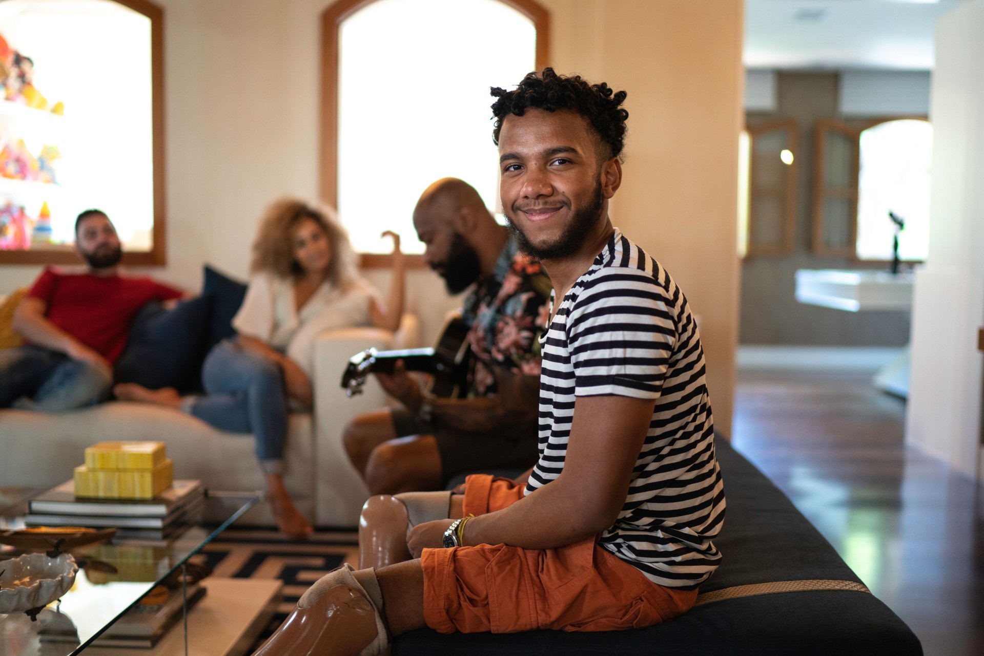 Portrait of a young man reunited with family in living room